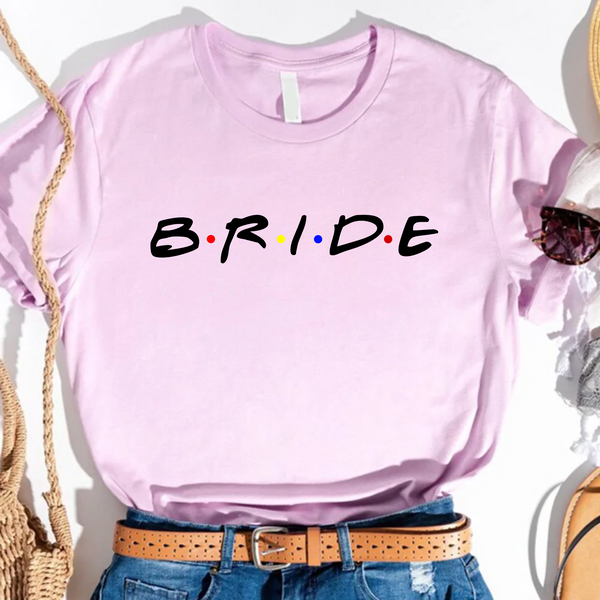 Lavender T-shirt with black text reading “Bride,”