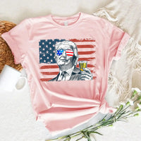 Pink t-shirt with a graphic of a historical figure holding a shot glass against an American flag background.
