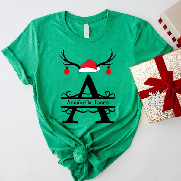 May include a personalized Christmas T-shirt with a single initial printed in a holiday-themed design on the front.