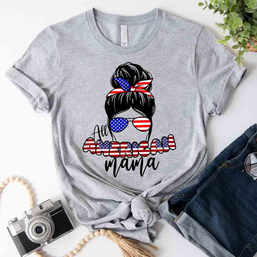 Gray custom tee with 'All American Mama' and USA flag graphic, styled with denim shorts.