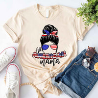 Beige patriotic graphic tee with 'All American Mama' and USA flag print, styled with denim shorts