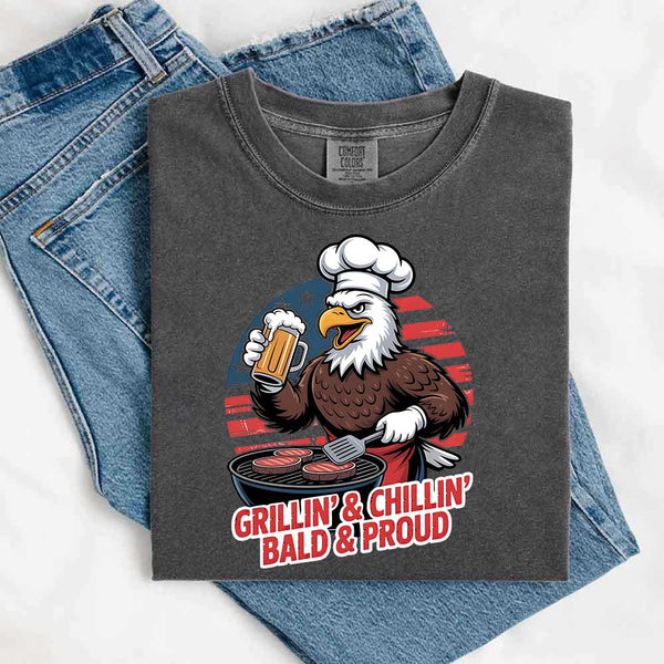 Gray t-shirt with an eagle graphic and text 'Grillin' & Chillin' Bald & Proud' on a white background.