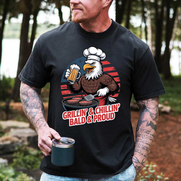 Man wearing a black t-shirt with an eagle graphic and text, standing outdoors.
