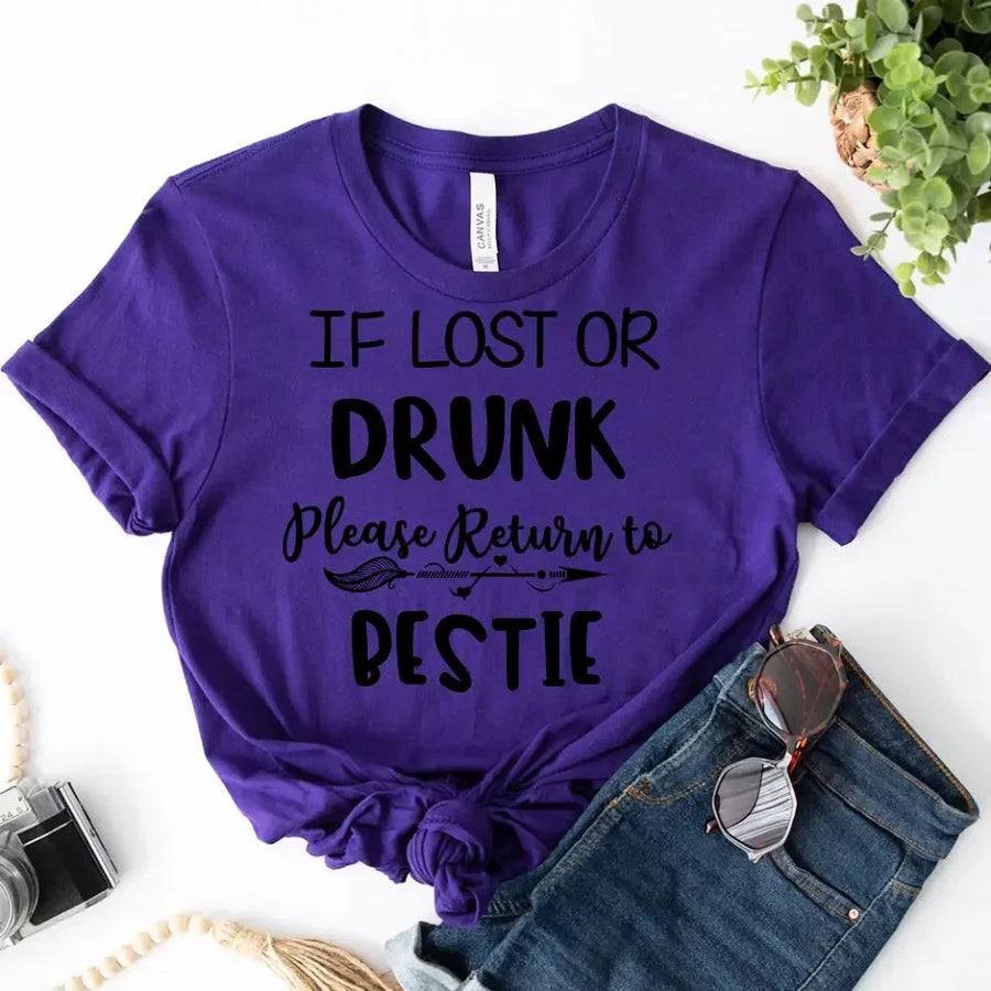Purple t-shirt with humorous text on a white background with jeans and sunglasses.