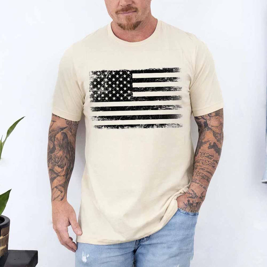 Man wearing a beige t-shirt with an American flag graphic on a white background