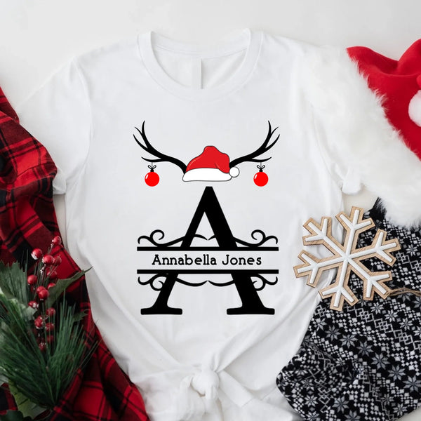 May include a personalized Christmas T-shirt with a single initial printed in a holiday-themed design on the front.