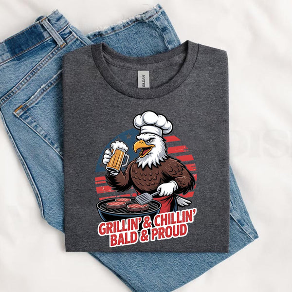 Gray t-shirt with an eagle graphic and text 'Grillin' & Chillin' Bald & Proud' on a white background.