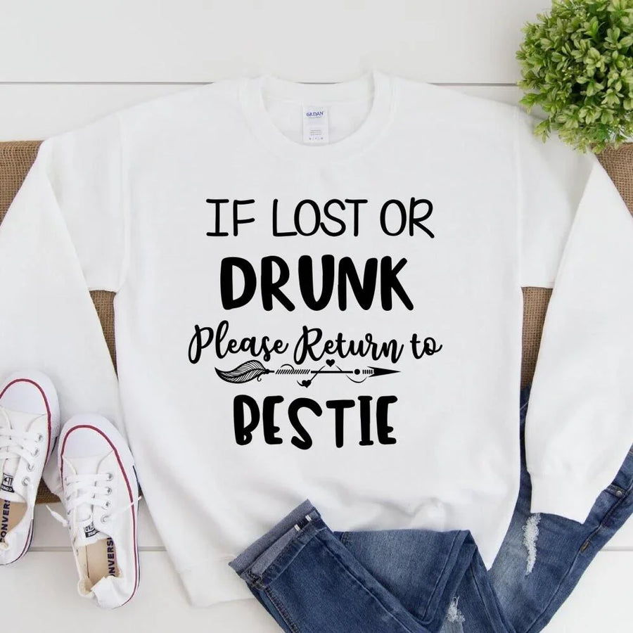 White sweatshirt with text 'If lost or drunk, please return to pestie' on a white background.