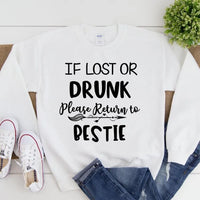 White sweatshirt with text 'If lost or drunk, please return to pestie' on a white background.