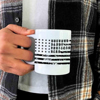 Hand holding white mug with black American flag and 'Husband Daddy Protector Hero' text