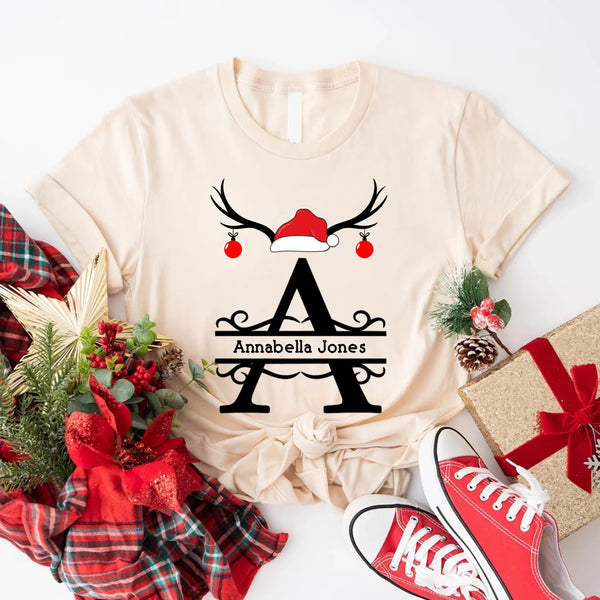 May include a personalized Christmas T-shirt with a single initial printed in a holiday-themed design on the front.
