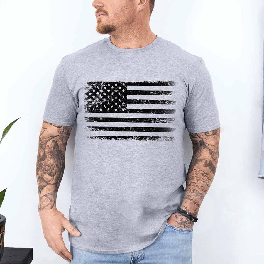 Man wearing a gray t-shirt with an American flag design on a white background