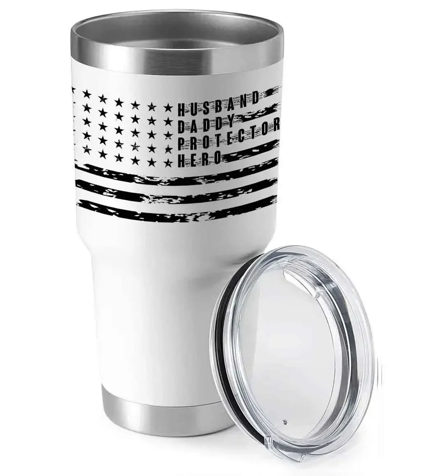 White insulated tumbler with black American flag design and text Husband Daddy Protector Hero, clear lid