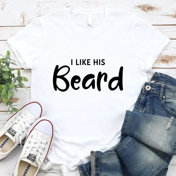 May include a pair of unisex couple t-shirts reading “I Like His Beard” and “I Like Her Butt,” displayed side by side in black and white cotton.