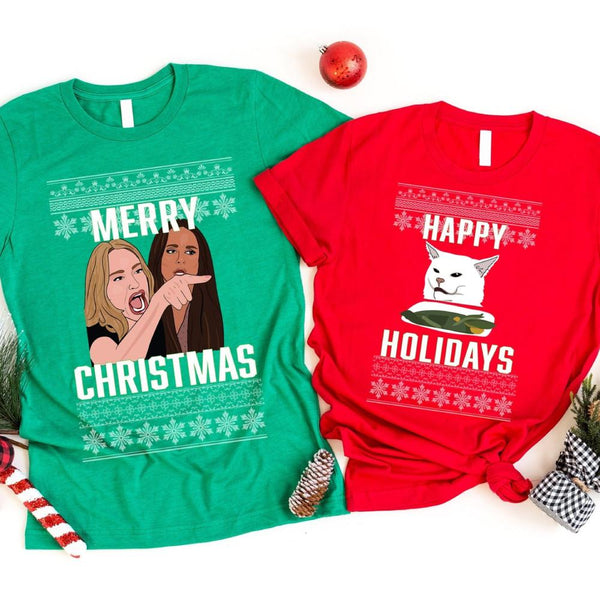 Two Christmas-themed t-shirts, one green with a graphic and text, the other red with a graphic and text, on a white background.