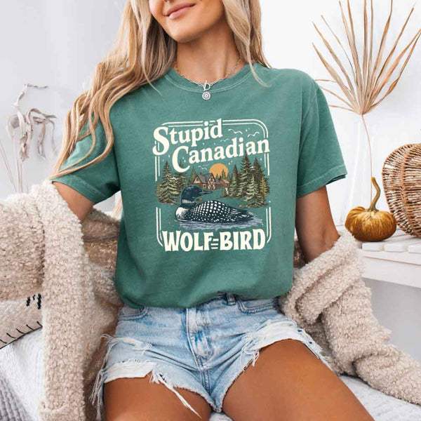 May include a person wearing a Light Green Stupid Canadian Wolf-Bird Comfort Colors T-Shirt featuring sports romance inspired graphic and relaxed fit.