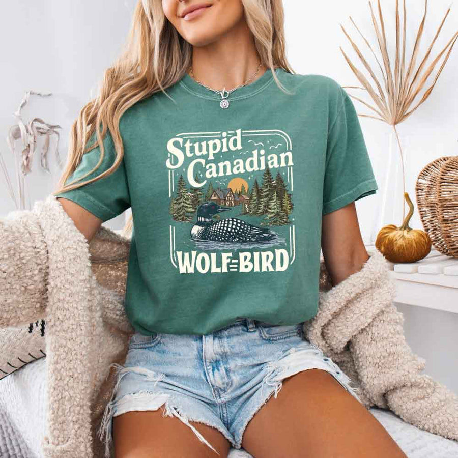 May include a person wearing a Light Green Stupid Canadian Wolf-Bird Comfort Colors T-Shirt featuring sports romance inspired graphic and relaxed fit.