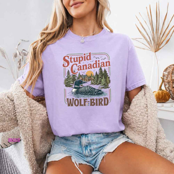 May include a person wearing a Orchid Stupid Canadian Wolf-Bird Comfort Colors T-Shirt featuring sports romance inspired graphic and relaxed fit.
