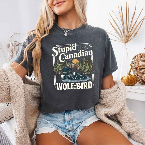 May include a person wearing a Pepper Stupid Canadian Wolf-Bird Comfort Colors T-Shirt featuring sports romance inspired graphic and relaxed fit.