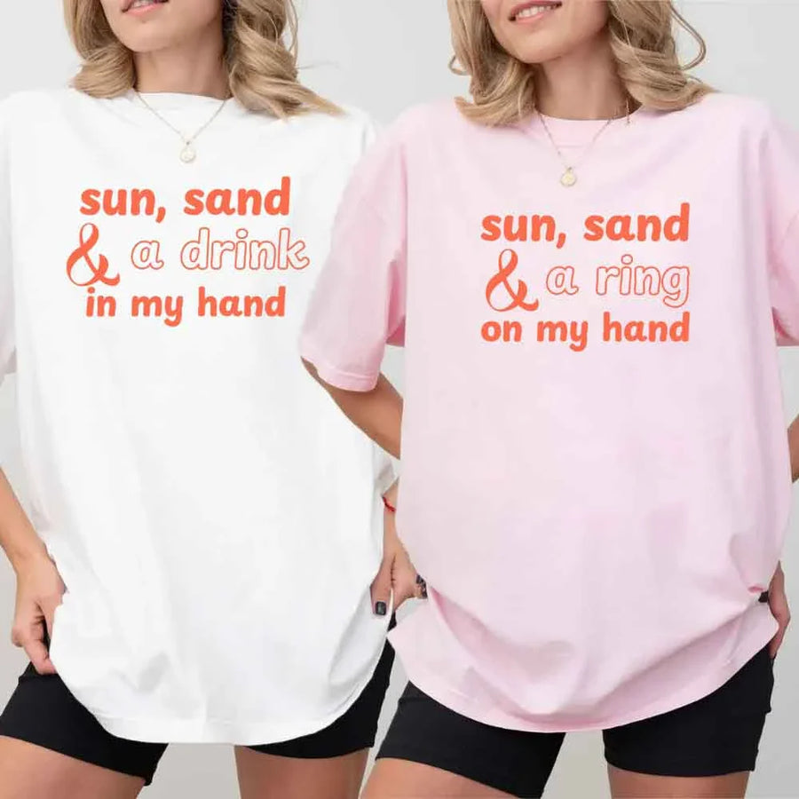 May include beach themed wedding party t-shirts with Sun Sand and A Ring On My Hand slogan, tropical colors, bridal group apparel for summer celebrations!