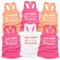 May include a tank top with the phrase “Sun Sand & A Ring On My Hand” in a stylish summer font, ideal for brides.