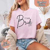 Soft  Pink Comfort Colors t-shirts with "Team Bride" design, perfect for the bride, bridesmaids, or bachelorette party, featuring stylish lettering for bridal proposals and celebrations.
