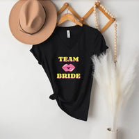 May include Team Bride & The Bride matching V-Neck T-Shirts for bachelorette party, with designs for bride and bridesmaids.