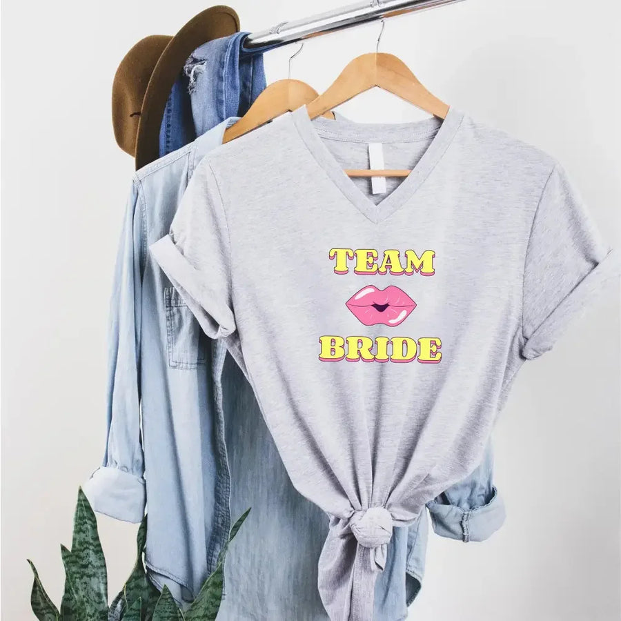 May include Team Bride & The Bride matching V-Neck T-Shirts for bachelorette party, with designs for bride and bridesmaids.