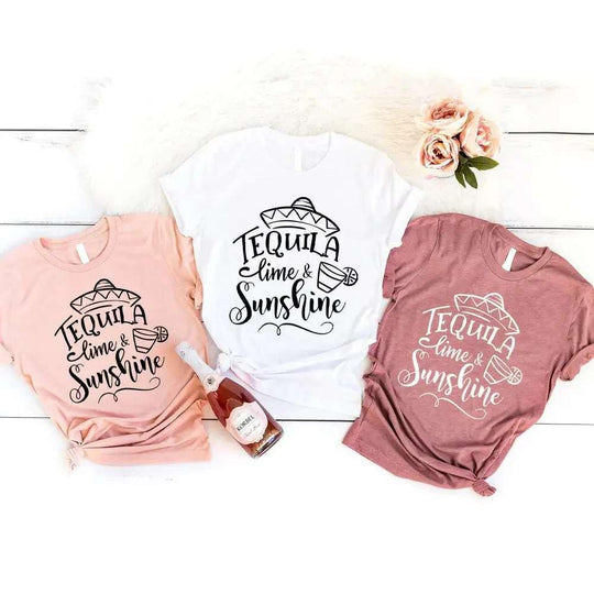 May include two people wearing matching best friend graphic t-shirts with “Tequila, Lime & Sunshine” text.