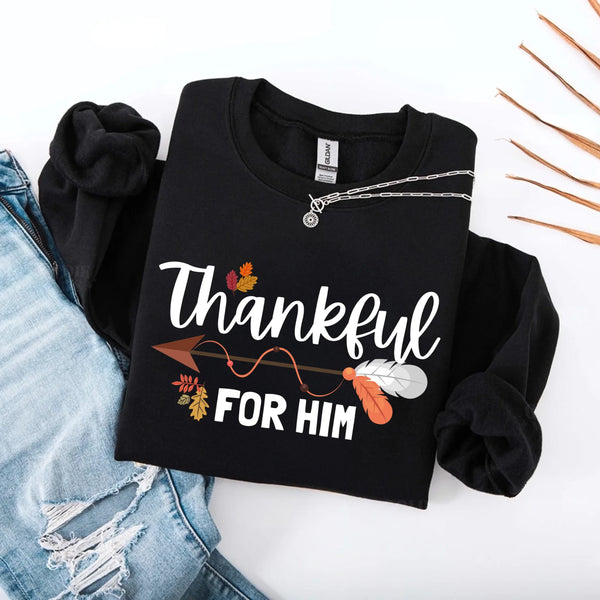 May include a pair of matching Thanksgiving sweatshirts featuring “Thankful For Her” and “Thankful For Him” text, styled for couples celebrating the holiday together.