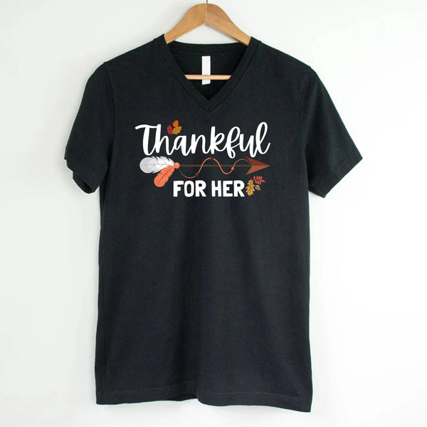 May include a pair of matching V-neck T-shirts with the phrases “Thankful For Her” and “Thankful For Him,” designed for couples celebrating Thanksgiving together.