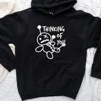 May include a t-shirt featuring the phrase “Thinking About You” in a clean or artistic font style. The design may use soft or minimalist colors, conveying a thoughtful, sentimental, or romantic message suitable for casual wear.