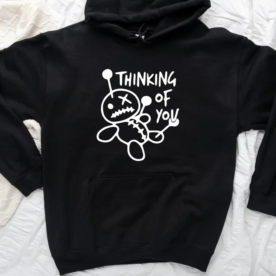 May include a t-shirt featuring the phrase “Thinking About You” in a clean or artistic font style. The design may use soft or minimalist colors, conveying a thoughtful, sentimental, or romantic message suitable for casual wear.