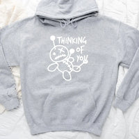 May include a t-shirt featuring the phrase “Thinking About You” in a clean or artistic font style. The design may use soft or minimalist colors, conveying a thoughtful, sentimental, or romantic message suitable for casual wear.
