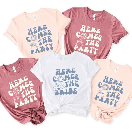 May include a bachelorette-themed T-shirt reading “Vino Before Vows,” featuring playful typography and celebratory bridal party design elements !