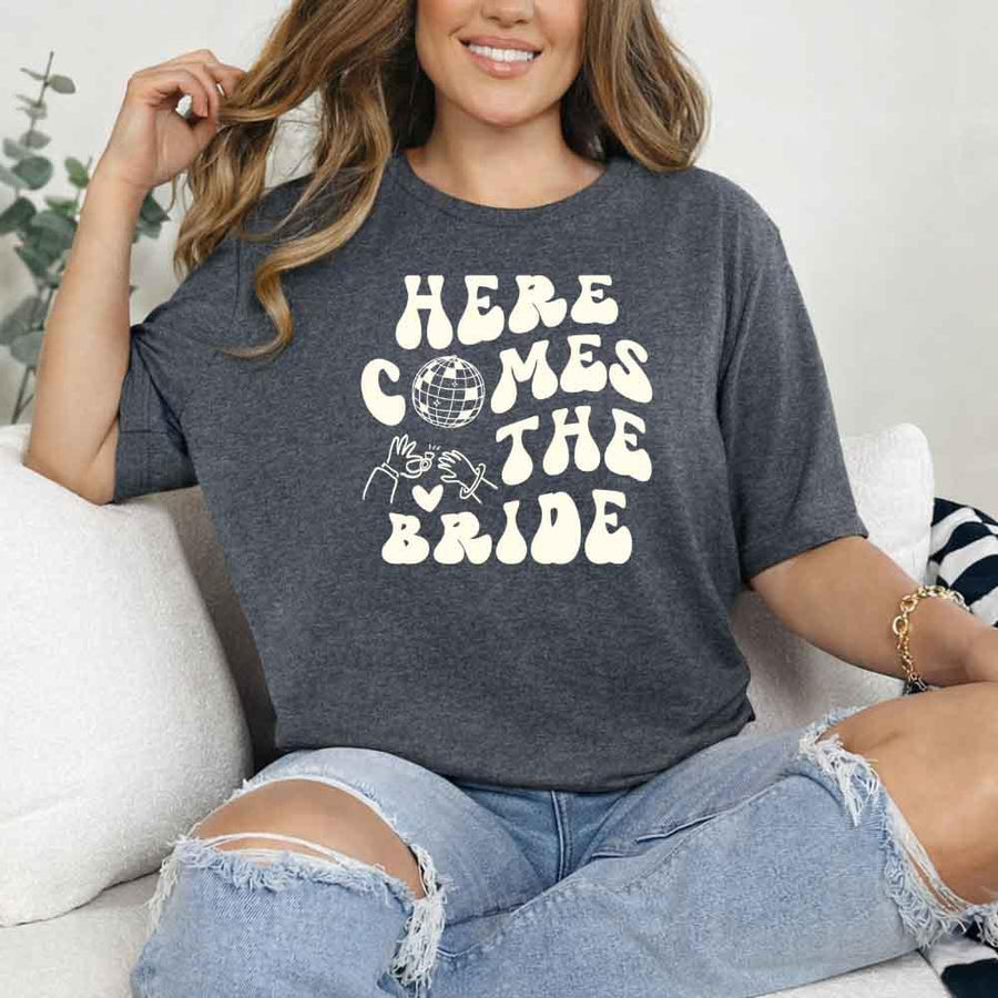 May include Dark Heather bachelorette-themed T-shirt reading “Vino Before Vows,” featuring playful typography and celebratory bridal party design elements!