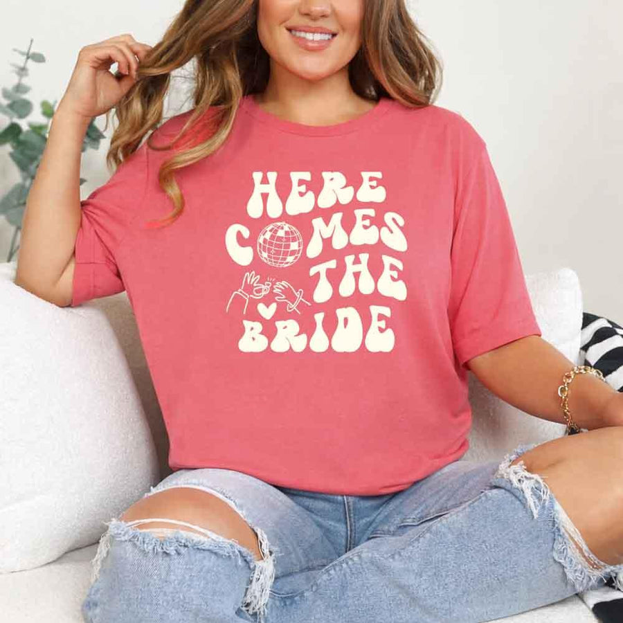 May include Coral Silk bachelorette-themed T-shirt reading “Vino Before Vows,” featuring playful typography and celebratory bridal party design elements!