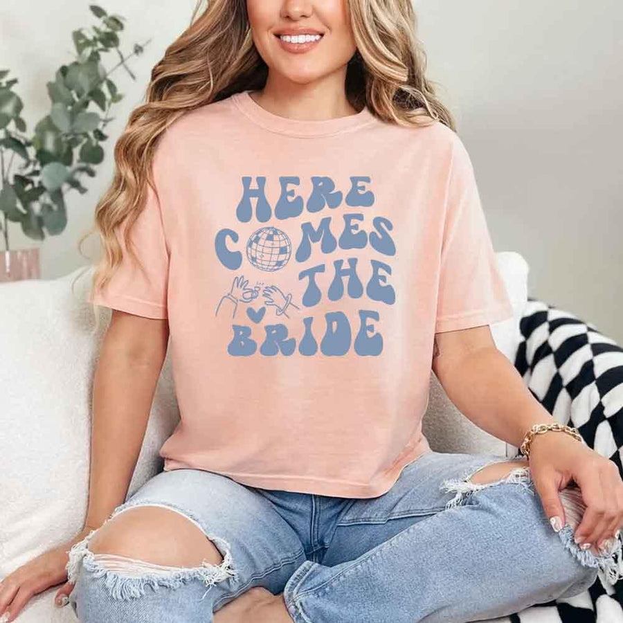 May include Peach bachelorette-themed T-shirt reading “Vino Before Vows,” featuring playful typography and celebratory bridal party design elements!