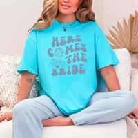 May include Turquoise bachelorette-themed T-shirt reading “Vino Before Vows,” featuring playful typography and celebratory bridal party design elements!