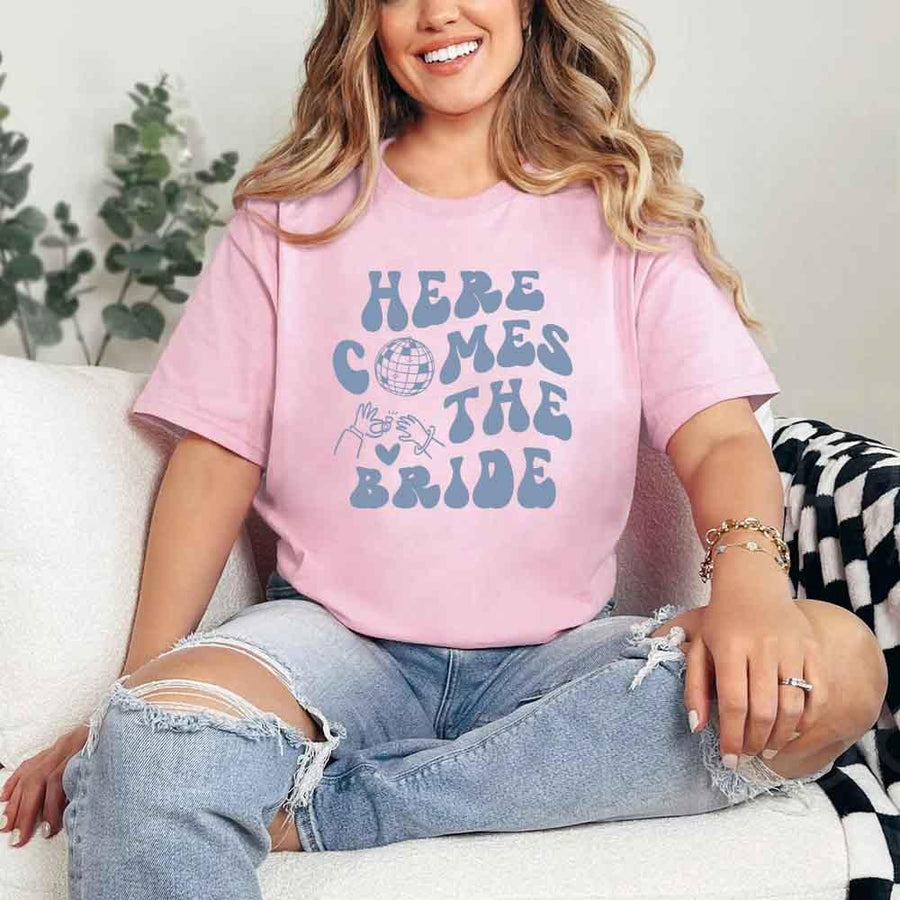 May include Pink bachelorette-themed T-shirt reading “Vino Before Vows,” featuring playful typography and celebratory bridal party design elements!