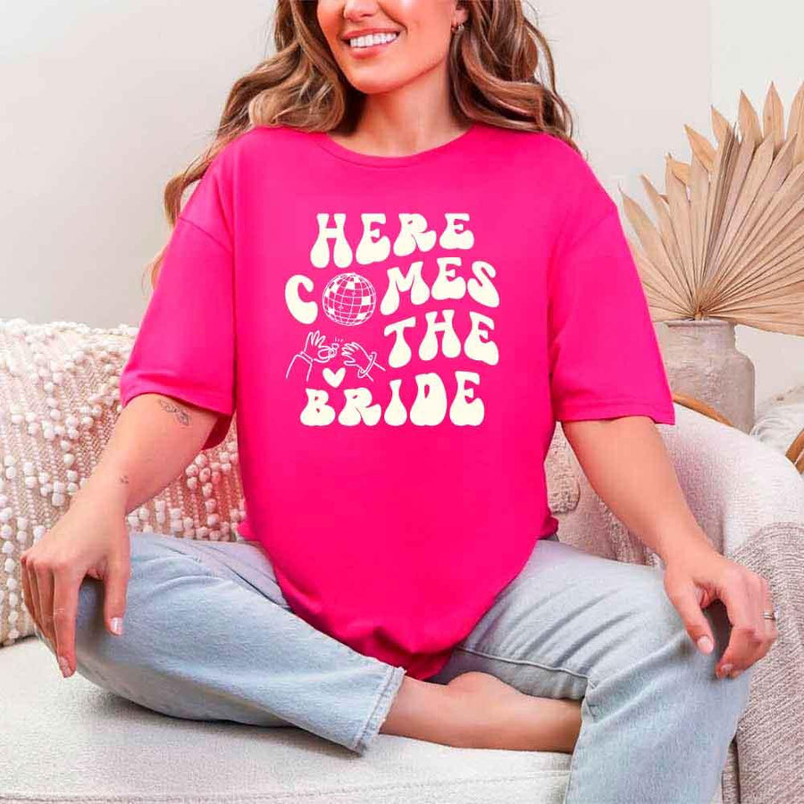 May include Heliconia bachelorette-themed T-shirt reading “Vino Before Vows,” featuring playful typography and celebratory bridal party design elements!
