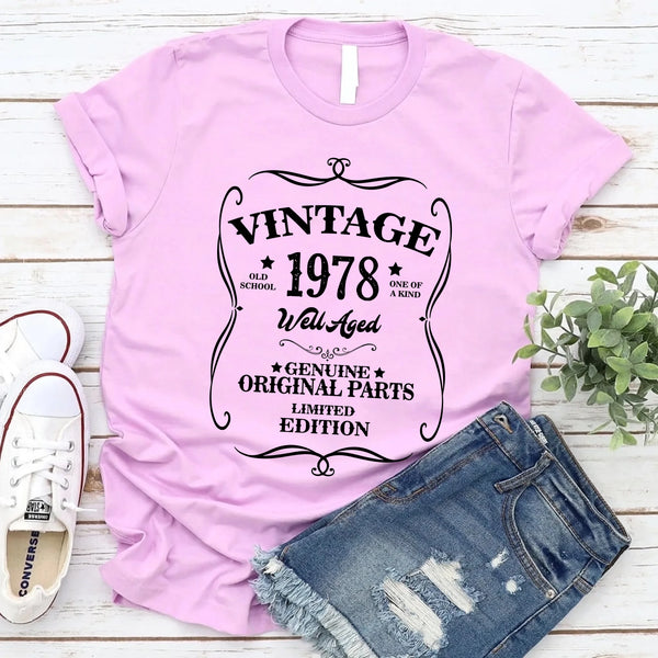 May include a personalized vintage-style birthday T-shirt with the words Well Aged and a custom year printed on the front.