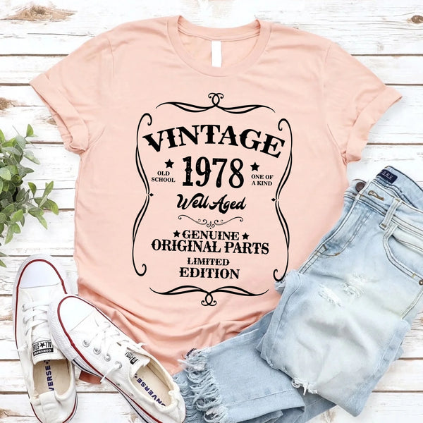 May include a personalized vintage-style birthday T-shirt with the words Well Aged and a custom year printed on the front.