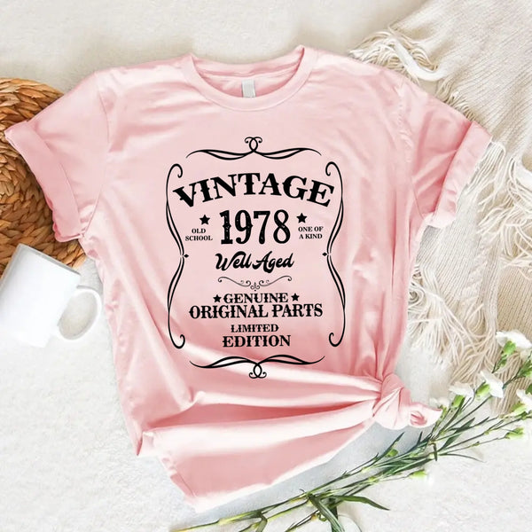 May include a personalized vintage-style birthday T-shirt with the words Well Aged and a custom year printed on the front.