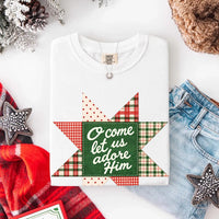 May include an O Come Let Us Adore Him Comfort Colors Christmas T-Shirt featuring a Christian holiday message inspired by a beloved Christmas hymn, designed for church services, family gatherings, worship events, and meaningful seasonal gifting.