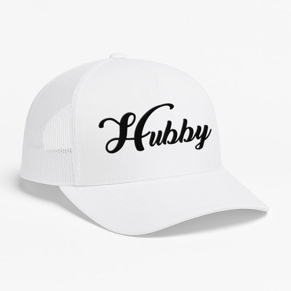 May include an embroidered trucker hat featuring the word “Hubby” stitched in clean, classic lettering on the front panel, designed with a structured crown and breathable mesh back for a timeless wedding or anniversary accessory.