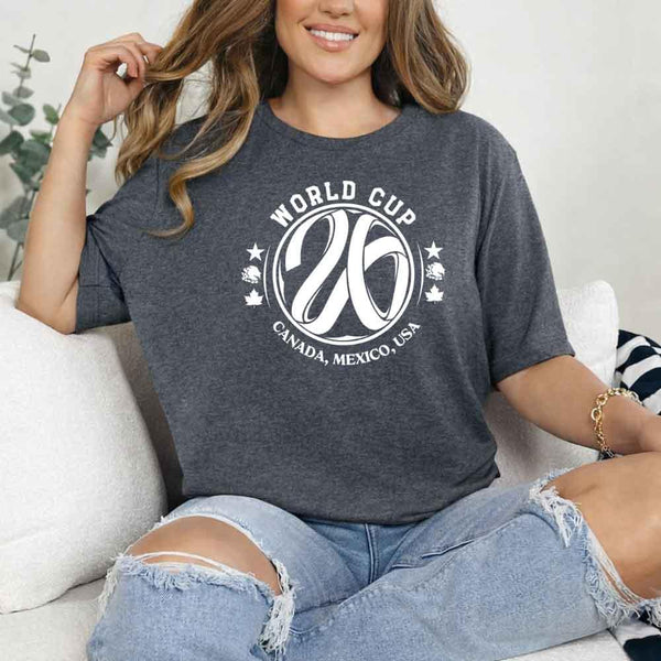 May include a person wearing a Dark Heather colored 2026 World Cup T-shirt featuring bold soccer graphic and relaxed fit.