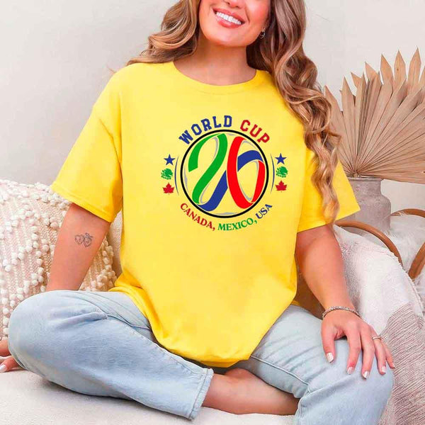 May include a person wearing a Daisy colored 2026 World Cup T-shirt featuring bold soccer graphic and relaxed fit.