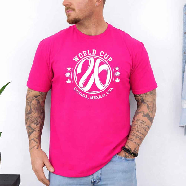 May include a person wearing a Heliconia colored 2026 World Cup T-shirt featuring bold soccer graphic and relaxed fit.