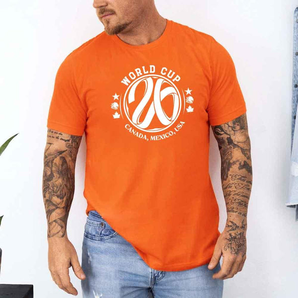May include a person wearing an Orange colored 2026 World Cup T-shirt featuring bold soccer graphic and relaxed fit.